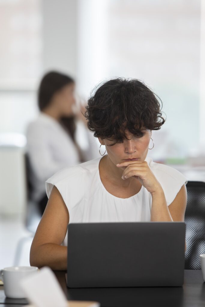 medium shot woman working with laptop